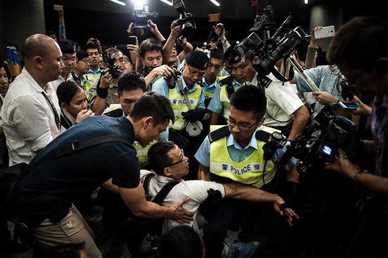 Police remove protesters from the grounds of the Legislative Council in Hong Kong, on June 14, 2014