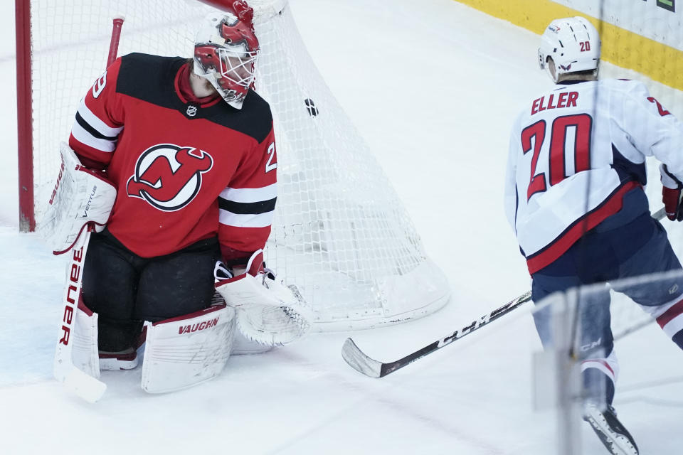 Washington Capitals center Lars Eller (20) skates against New Jersey Devils goaltender Mackenzie Blackwood (29) during the first period of an NHL hockey game, Saturday, Feb. 27, 2021, in Newark, N.J. (AP Photo/Mary Altaffer)