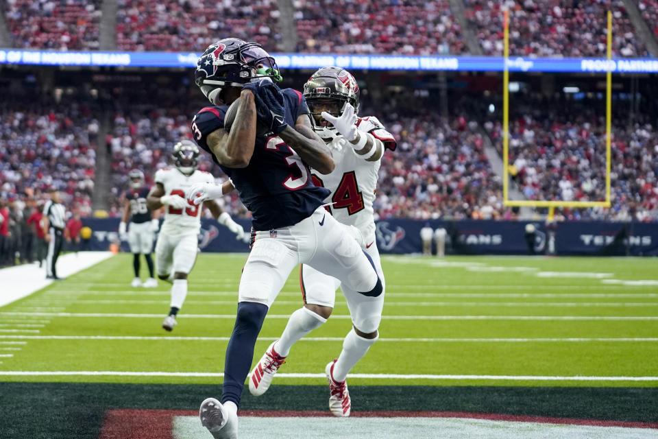 Houston Texans wide receiver Tank Dell (3) collects a touchdown catch in front of Tampa Bay Buccaneers cornerback Carlton Davis III (24) during the second half of an NFL football game, Sunday, Nov. 5, 2023, in Houston. (AP Photo/Eric Gay)