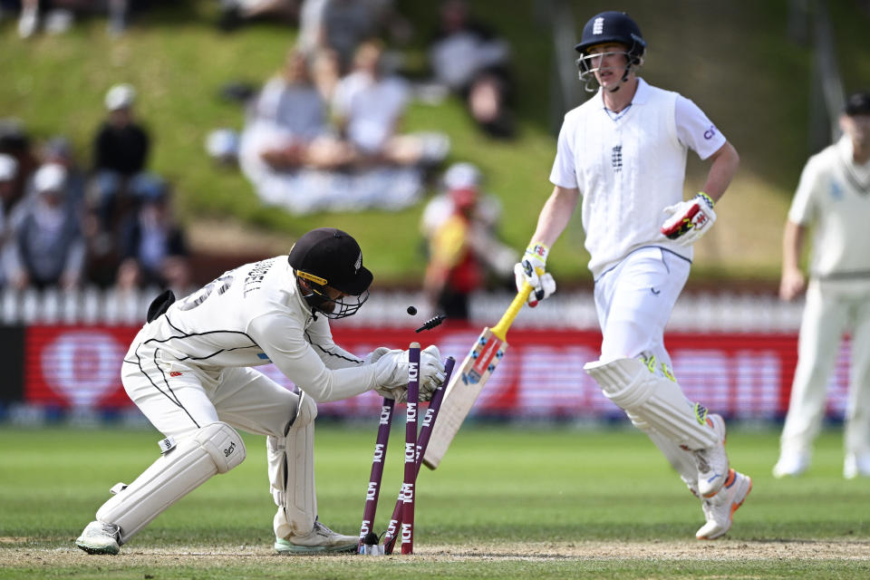 New Zealand's Tom Blundell, left, runs out England's Harry Brook on day 5 of their cricket test match in Wellington, New Zealand, Tuesday, Feb 28, 2023. (Andrew Cornaga/Photosport via AP)