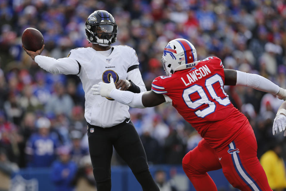 Baltimore Ravens quarterback Lamar Jackson (8) gets off a pass under pressure by Buffalo Bills defensive end Shaq Lawson (90) during the first half of an NFL football game in Orchard Park, N.Y., Sunday, Dec. 8, 2019. (AP Photo/John Munson)