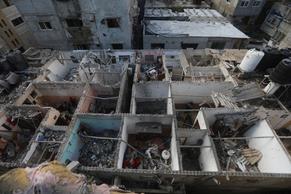 Palestinians look at the destruction after an Israeli strike on residential building in Rafah, Gaza Strip, Tuesday, May 7, 2024. (AP Photo/Ismael Abu Dayyah)