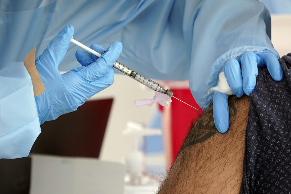 A COVID-19 vaccine is administered at a site for health care workers at Ritchie Valens Recreation Center, Wednesday, Jan. 13, 2021, in Pacoima, Calif. (AP Photo/Marcio Jose Sanchez)