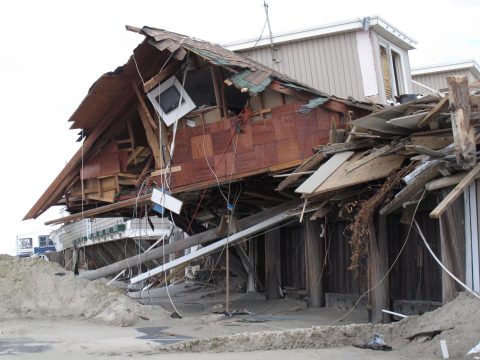 This Nov. 15, 2012 photo shows the remnants of an oceanfront building in Sea Bright N.J. that was destroyed by Superstorm Sandy. On Thursday, Oct. 15, 2020, New Jersey officials released a report committing the state to try to reduce its greenhouse gas emissions by 80% by the year 2050 to help fight climate change and rising sea levels. (AP Photo/Wayne Parry)