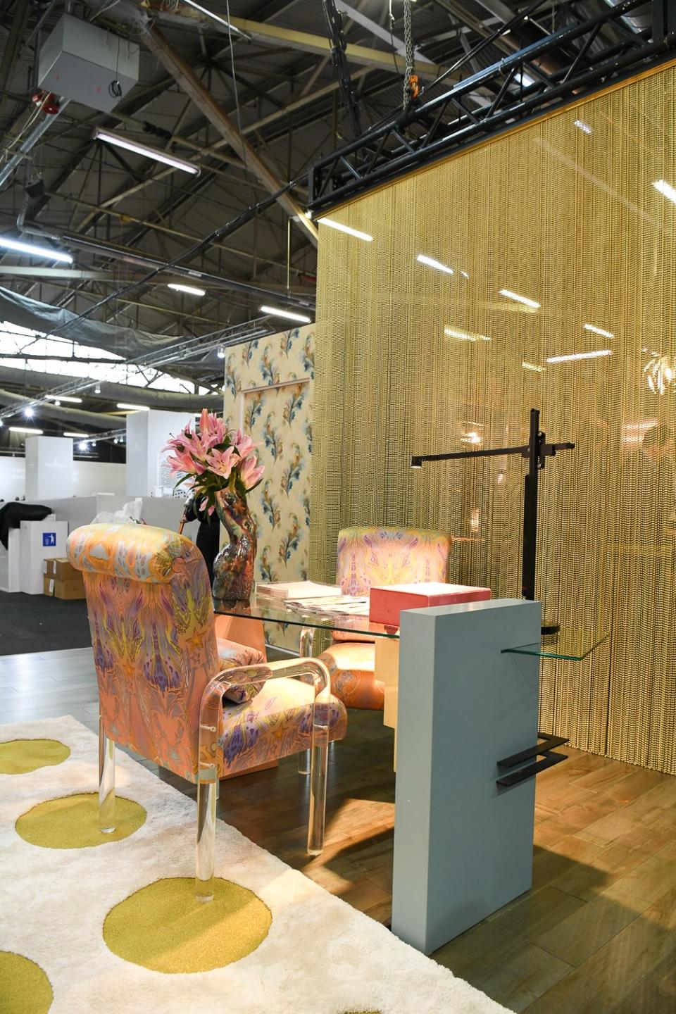 Hanging brass bead curtain by ShimmerScreen, desk lamp by Dyson, desk, chairs, and rug; Bikoff’s own.