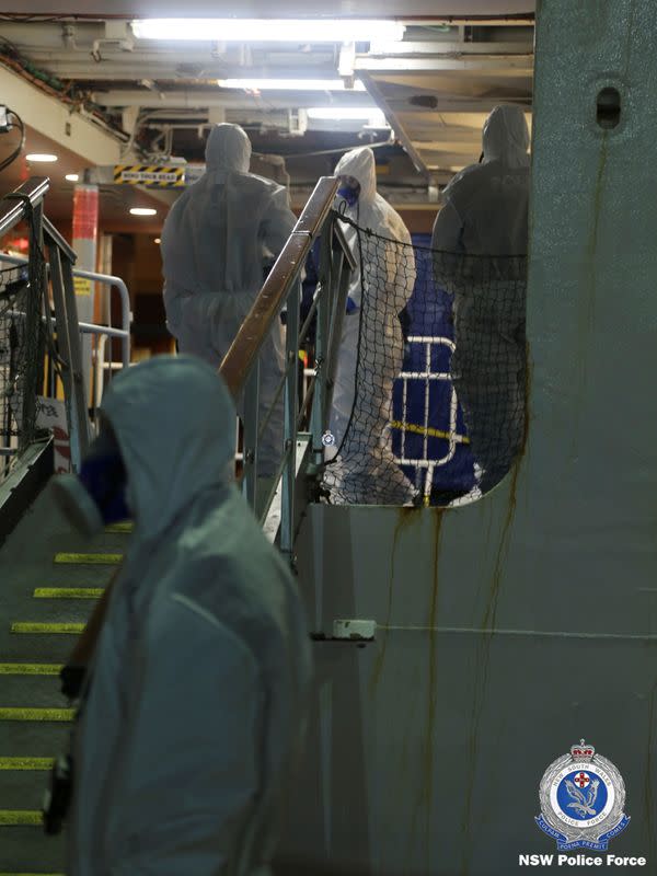 NSW Police personnel in personal protective equipment board the Ruby Princess during the Strike Force Bast raid of the cruise ship at Port Kembla