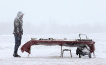 <p>A street vendor selling souvenirs waits for customers during a snow fall in the Aziarco village, Belarus, February 25, 2017. (Vasily Fedosenko/Reuters) </p>