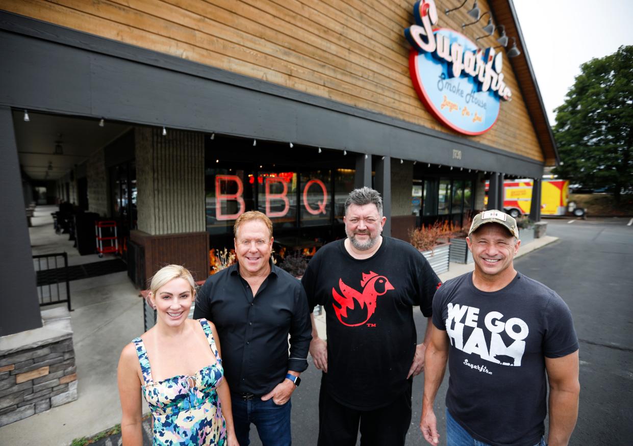 Sugarfire Smoke House owners Erin and David Whitman, chef Clint McCann and owner David Burke outside the south Springfield restaurant on Thursday, July 6, 2023.