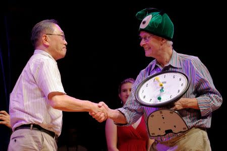 Nobel Laurette Rich Roberts (R) presents the 2016 Ig Nobel Prize in Perception to Atsugi Higashiyama of Japan for "investigating whether things look different when you bend over and view them between your legs" during the 26th First Annual Ig Nobel Prize ceremony at Harvard University in Cambridge, Massachusetts, U.S. September 22, 2016. REUTERS/Brian Snyder