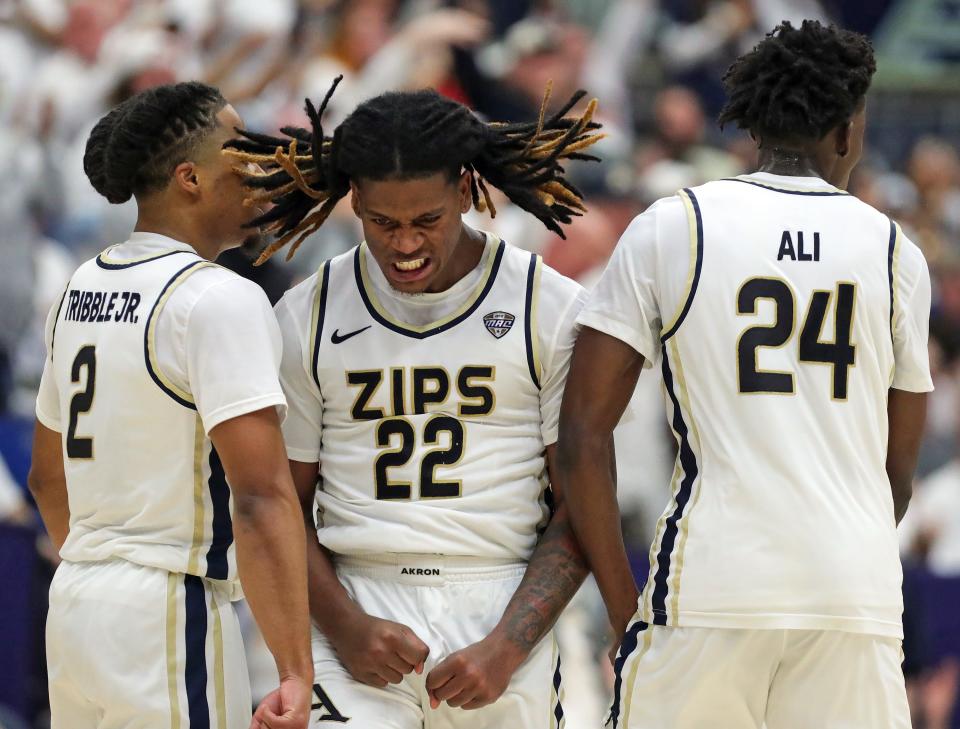 Akron Zips guard Mikal Dawson (22) celebrates after a corner three with guard Greg Tribble (2) and guard Ali Ali (24) during the second half of an NCAA college basketball game against the Kent State Golden Flashes, Friday, Feb. 23, 2024, in Akron, Ohio.