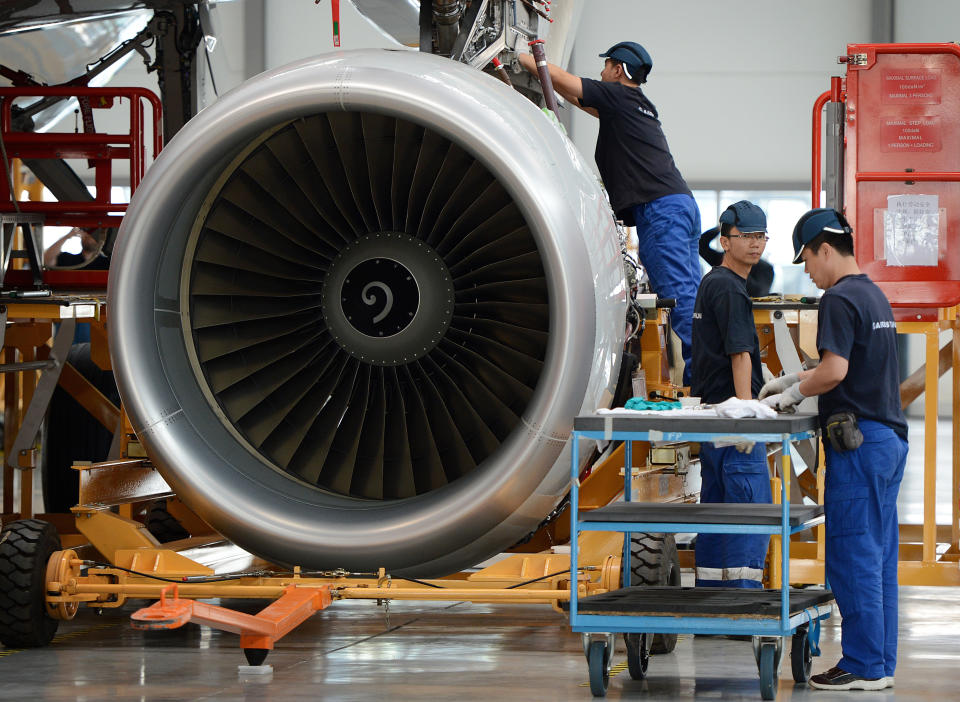 Airbus employees install an engine on an A320 plane under construction at the final assembly line of Airbus factory in the northern port city of Tianjin on June 13, 2012.  Tony Tyler who is the head of airline industry group IATA urged the European Union to postpone its controversial carbon tax scheme, amid warnings it could spark a trade war that would penalise Europe. China's aviation watchdog forbade Chinese airlines from participating in the so-called Emissions Trading Scheme (ETS).      AFP PHOTO/Mark RALSTON        (Photo credit should read MARK RALSTON/AFP/GettyImages)