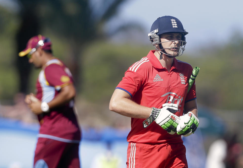 England's Luke Wright leaves the field after he was caught by West Indies' Darren Sammy during their first one-day international cricket match at the Sir Vivian Richards Cricket Ground in St. John's, Antigua, Friday, Feb. 28, 2014. (AP Photo/Ricardo Mazalan)