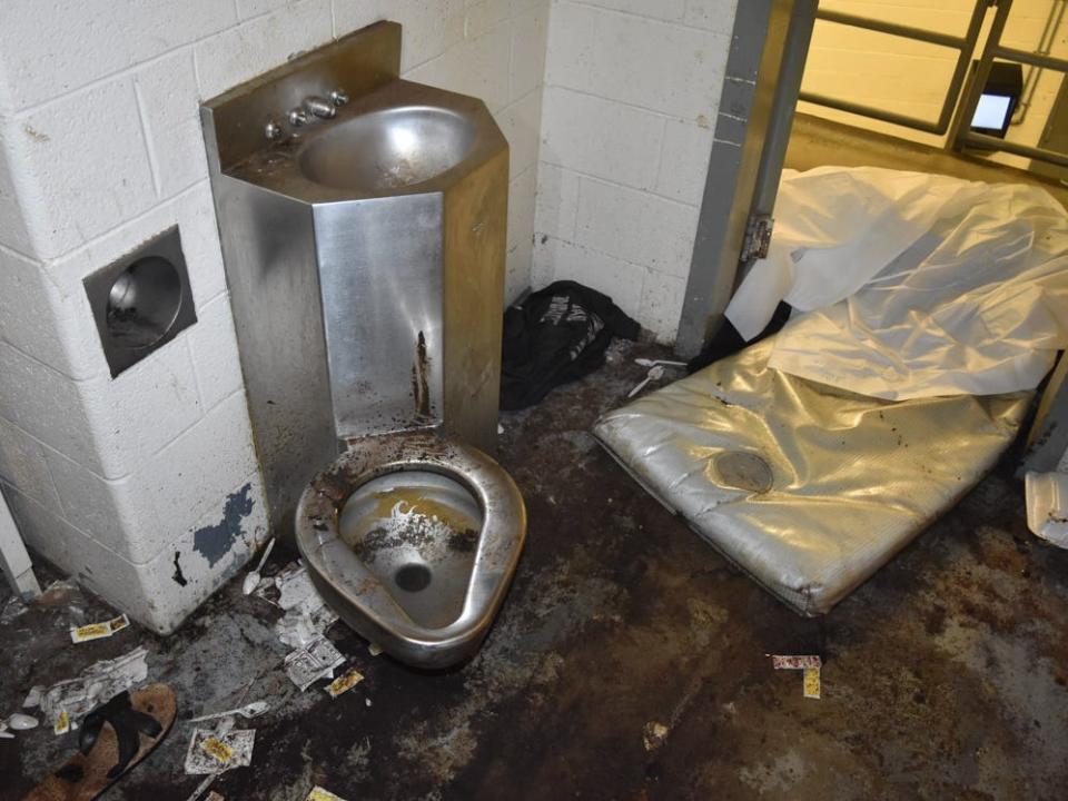 Photos of the jail cell where Lashawn Thompson was held show squalid conditions.