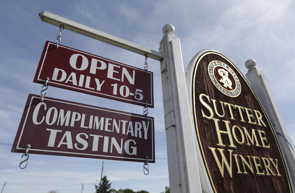 In this photo taken Saturday, April 13, 2013 a sign for complimentary tastings hangs outside Sutter Home Winery in St. Helena, Calif. The days when winery owners routinely poured their wares for free are no more, but there is still at least one winery offering tariff-free tasting, Sutter Home Family Vineyards _ the people who introduced America to white zinfandel in the 1970s _ in St. Helena. (AP Photo/Eric Risberg)