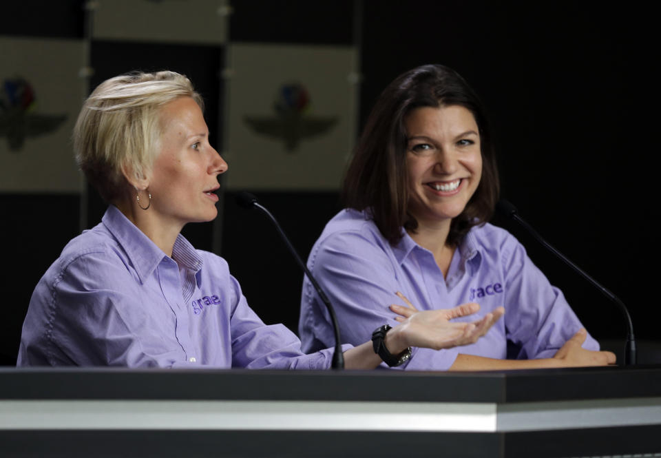 FILE - In this May 15, 2015, file photo, Beth Paretta, left, and driver Katherine Legge announce the formation of Grace Autosport, the first all female IndyCar Series racing team during a press conference at Indianapolis Motor Speedway in Indianapolis. The effort stalled when Paretta's team couldn't find a suitable car. Paretta and Simona de Silvestro will be teaming up to put another woman on the Indianapolis 500 starting grid this May. On Tuesday, Jan. 19, 2021, Paretta Autosport and IndyCar officials announced they would work together to put a predominantly women-run team in the series' biggest race as part of an outreach to create more diversity in motorsports. (AP Photo/Michael Conroy, File)