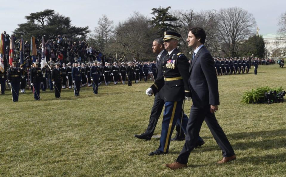 President Barack Obama and Canadian Prime Minister Justin Trudeau walk to review the troops during a state arrival ceremony on the South Lawn of White House in Washington, Thursday, March 10, 2016. (AP Photo/Susan Walsh)