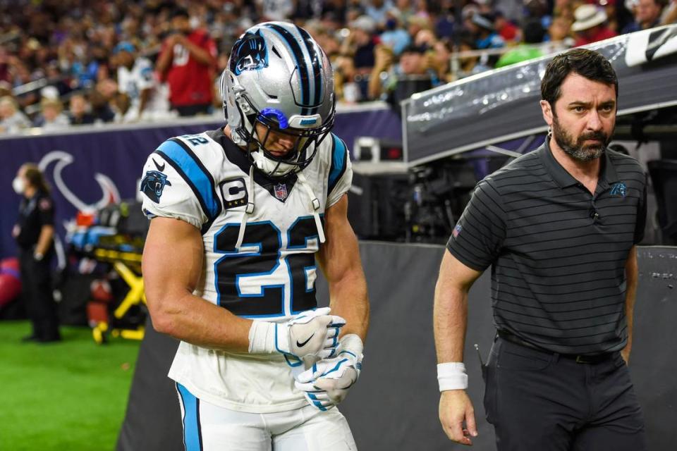 Panthers running back Christian McCaffrey, left, walks to the locker room with team athletic trainer Jean-Baptise Laporte after a hamstring injury during the game against the Texans at NRG Stadium on Thursday, September 21, 2021 in Houston, TX.