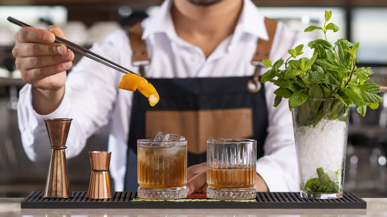 bartender makes whiskey cocktails