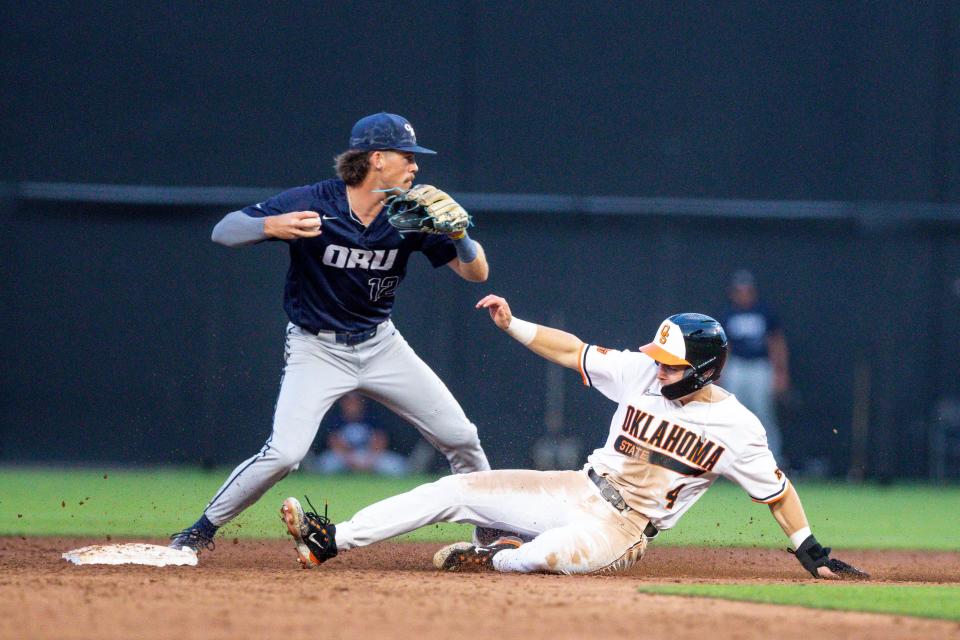 Oklahoma State utility Zach Ehrhard (4) slides into second and is tagged out by Oral Roberts infielder Mac McCroskey (12) during a game in the NCAA Stillwater Regional between the Oklahoma State Cowboys (OSU) and the Oral Roberts Golden Eagles at O'Brate Stadium in Stillwater, Okla., on Friday, June 2, 2023.