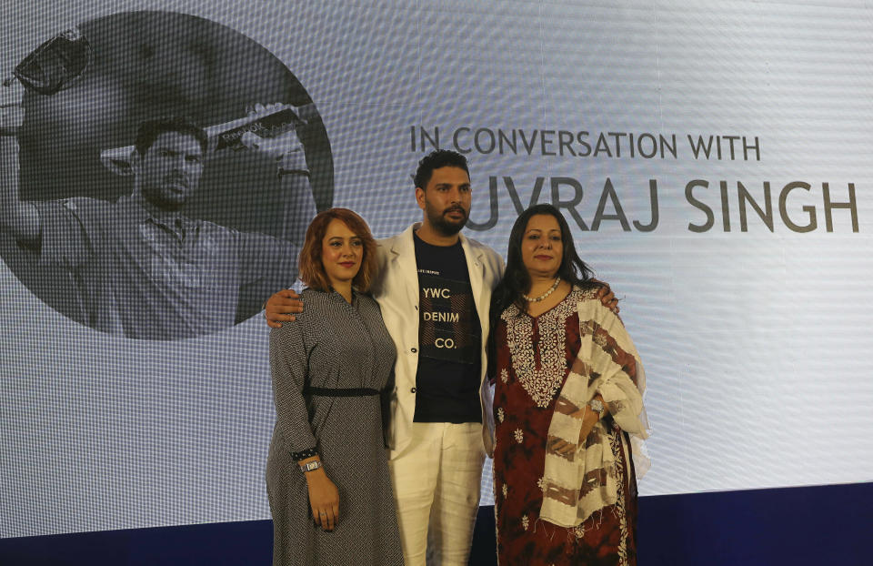 Indian cricket player Yuvraj Singh, center, poses for a picture with his mother Shabnam Singh, right, and wife Hazel Keech after announcing his retirement from international cricket in Mumbai, India, Monday, June 10, 2019. (AP Photo/Rafiq Maqbool)