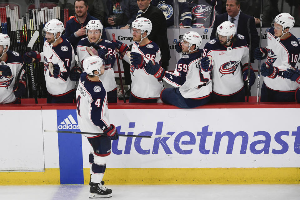 Columbus Blue Jackets' Cole Sillinger (4) celebrates with teammates at the bench after scoring a goal during the second period of an NHL hockey game against the Chicago Blackhawks, Saturday, March 2, 2024, in Chicago. (AP Photo/Paul Beaty)