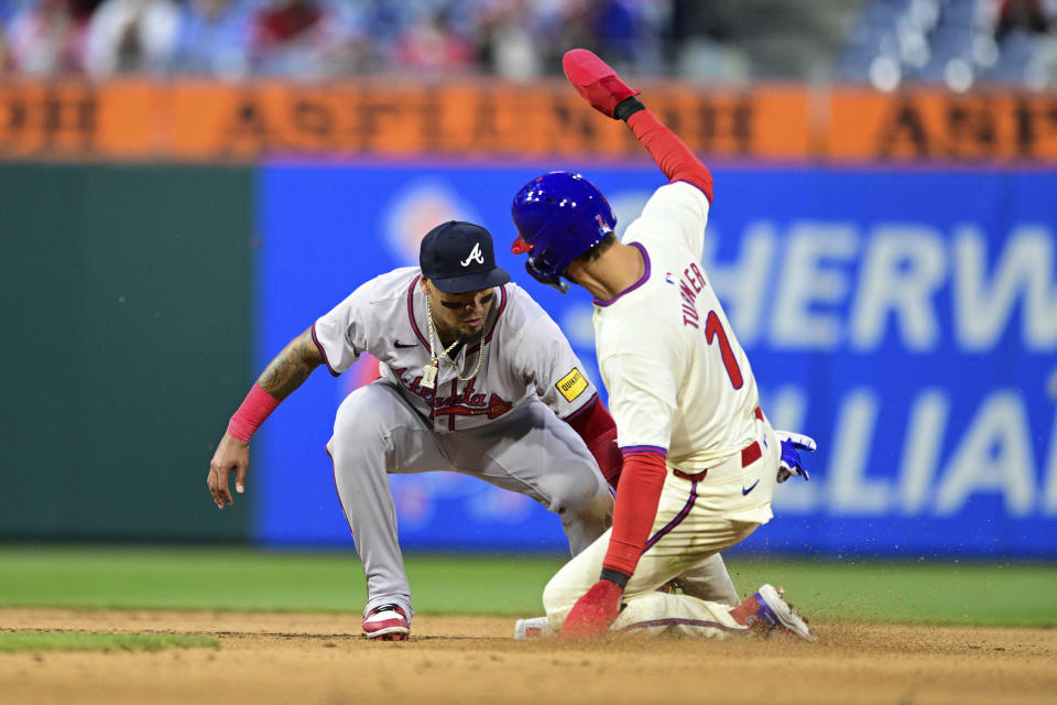 Atlanta Braves' Orlando Arcia, left, tags out Philadelphia Phillies' Trea Turner (7) after Bryce Harper hit into a double play during the seventh inning of a baseball game, Saturday, March 30, 2024, in Philadelphia. (AP Photo/Derik Hamilton)