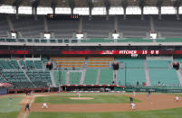 Stadium seats are empty as a part of precaution against the new coronavirus during a baseball game between Hanwha Eagles and SK Wyverns in Incheon, South Korea, Tuesday, May 5, 2020. With umpires fitted with masks and cheerleaders dancing beneath vast rows of empty seats, a new baseball season got underway in South Korea following a weeks-long delay because of the coronavirus pandemic. (AP Photo/Lee Jin-man)