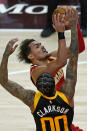 Atlanta Hawks guard Trae Young goes to the basket as Utah Jazz guard Jordan Clarkson (00) defends during the first half of an NBA basketball game Friday, Jan. 15, 2021, in Salt Lake City. (AP Photo/Rick Bowmer)