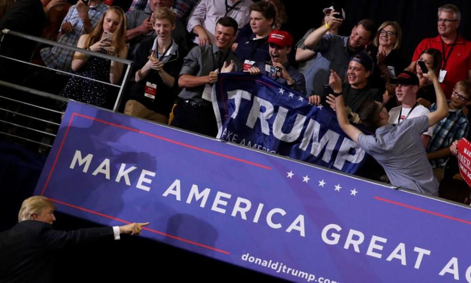 A supporter takes a selfie from the balcony as Donald Trump departs at the end of a rally in Duluth, Minnesota.