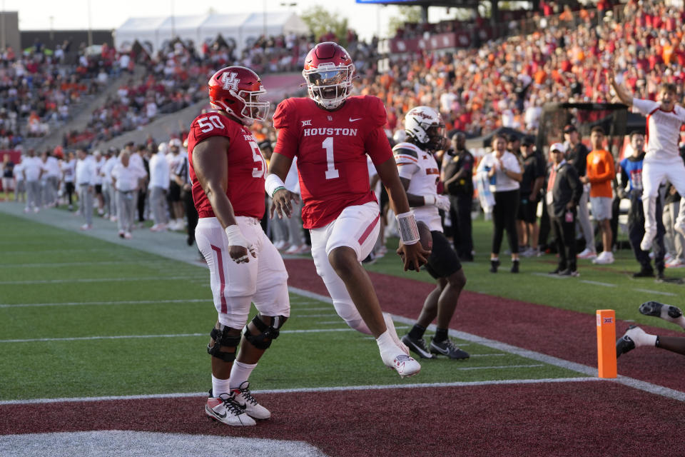 Houston quarterback Donovan Smith (1) leaps into the end zone for a touchdown after catching a pass against Oklahoma State during the first half of an NCAA college football game Saturday, Nov. 18, 2023, in Houston. (AP Photo/David J. Phillip)