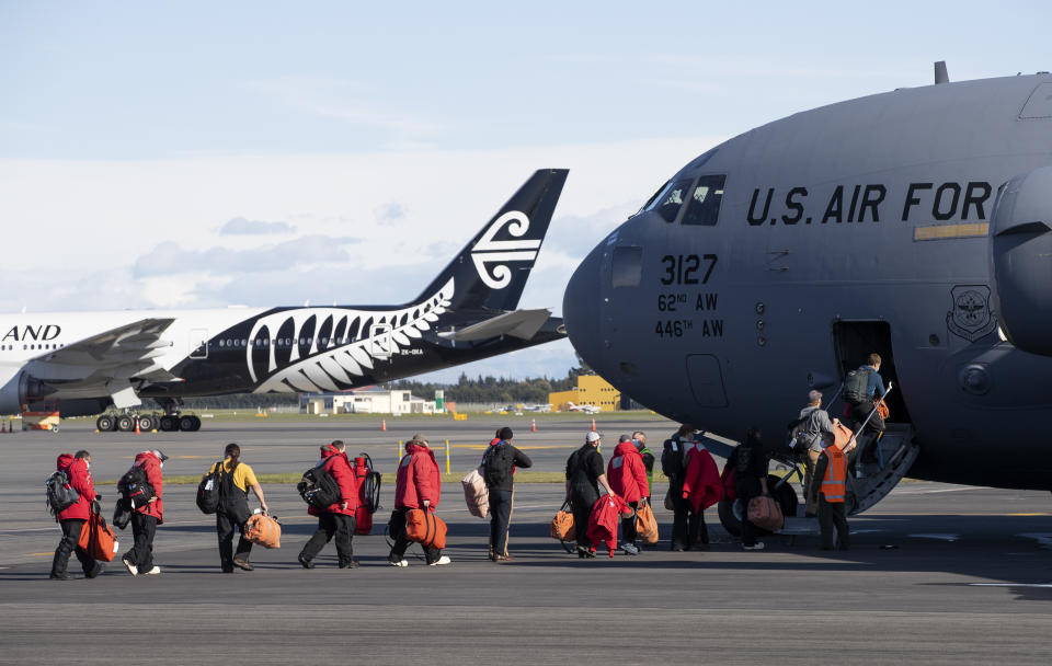 Staff board a U.S. Air Force C-17 as they prepare to take the season's first flight to McMurdo Station in Antarctica from Christchurch Airport, New Zealand, Monday, Sept. 14, 2020. The first U.S. flight into Antarctica following months of winter darkness left from New Zealand Monday with crews extra vigilant about keeping out the coronavirus. (AP Photo/Mark Baker)