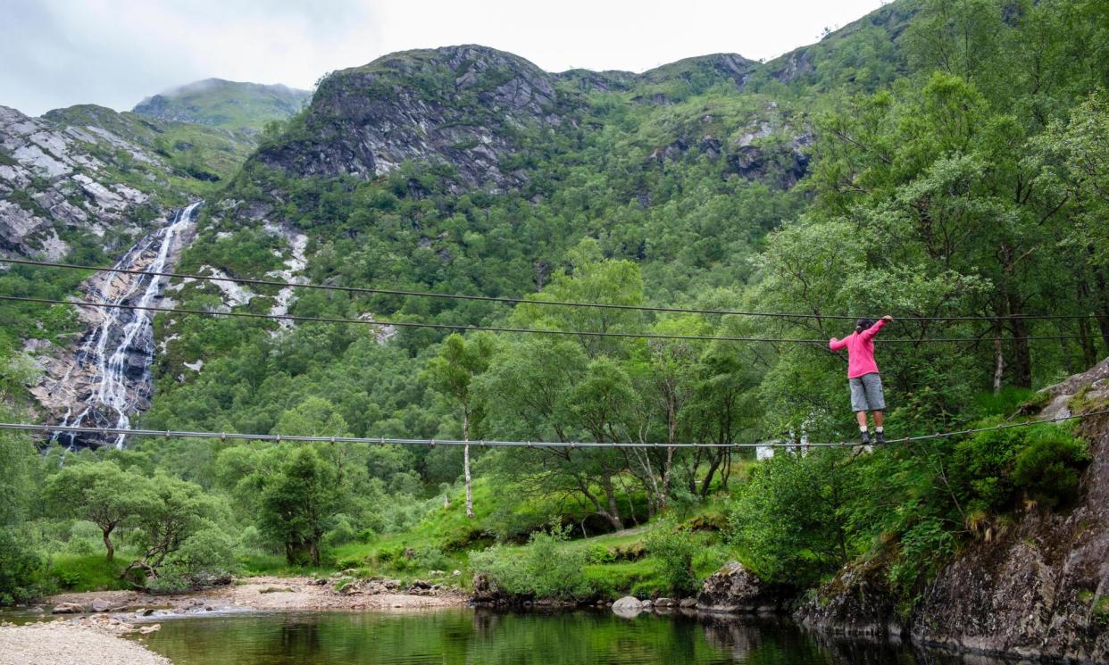 <span>Crossing the Waters of Nevis via the Steall Falls wire bridge.</span><span>Photograph: Pearl Bucknall/Alamy</span>