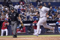 New York Yankees' Anthony Rizzo, right, scores on a wild pitch by Miami Marlins reliever Anthony Bender during the fifth inning of a baseball game, Saturday, July 31, 2021, in Miami. (AP Photo/Lynne Sladky)