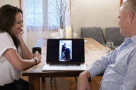 Brenda and Brian Lilly watch a video of their son, Brian Lilly Jr., deliver a speech to his rowing team, Thursday, Oct. 13, 2022, in Easton, Conn. Brian Lilly Jr., 19, who committed suicide on Jan. 4, 2021, was a rower at University of California San Diego. The Lillys have filed a wrongful death lawsuit against the university and the rowing coach, Geoff Bond, who is no longer with the school. (AP Photo/Julia Nikhinson)