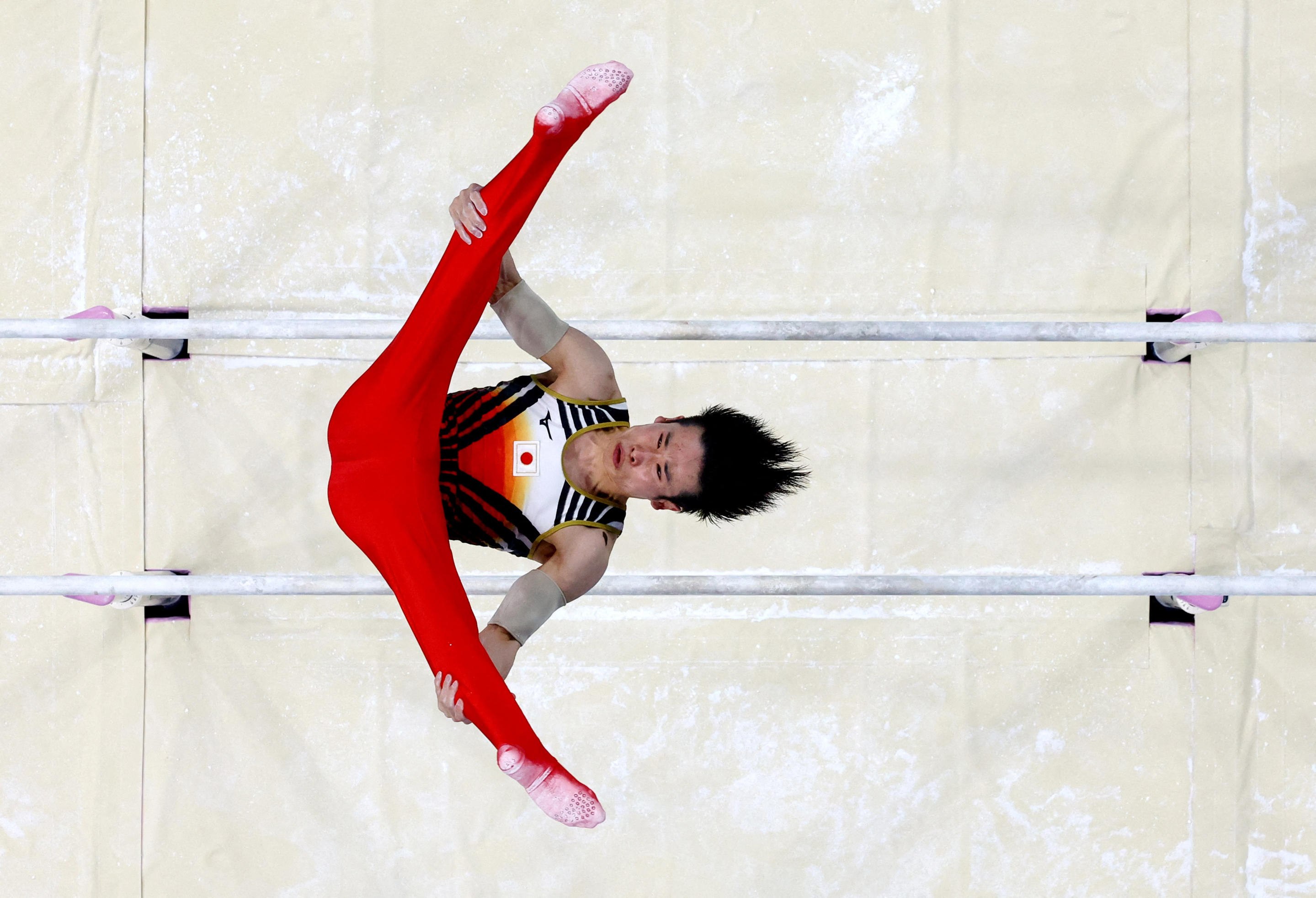 Kazuma Kaya of Japan in action on the Parallel bars during the Men's Team Final in Artistic Gymnastics on July 29, 2024. (Athit Perawongmetha/Reuters)