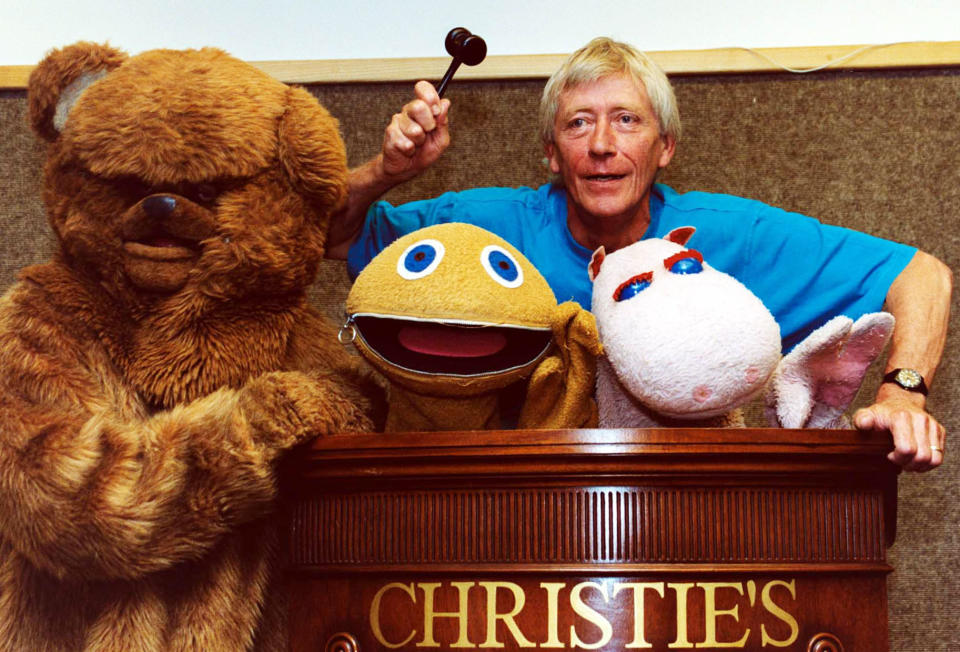 Geoffrey Hayes former presenter of the Children's TV Programme Rainbow with Zippy (centre), George and Bungle (left), at Christie's in South Kensington, to promote the TV Generation Auction taking place at the Auction house.  * The original puppets and costumes for the three char 2,000 -   3,000.   (Photo by Tony Harris - PA Images/PA Images via Getty Images)