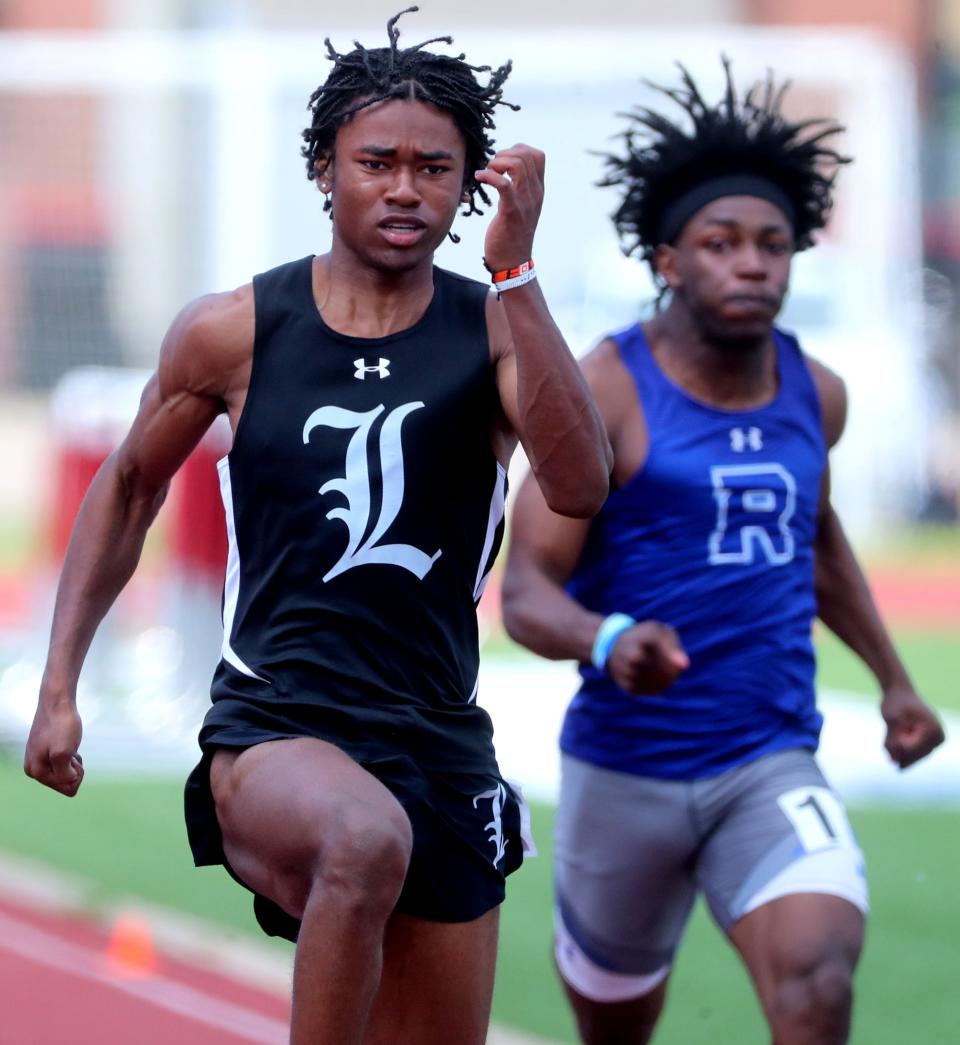 La Vergne's John Sherman competes in the boys 100 meter dash as Rockvale's Mar'caseus Midgett comes up from behind him during the Class-AA Section 2 Sectional Track and Field meet on Tuesday, April 9, 2023, at Stewarts Creek.