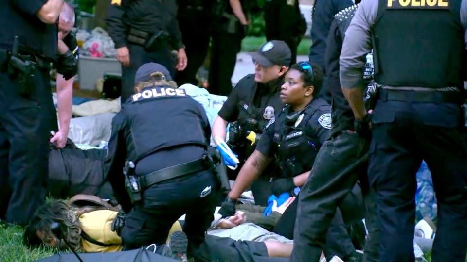 Law enforcement officers detain Pro-Palestinian protesters in their encampment on the UNC campus Tuesday morning, April 30, 2024.