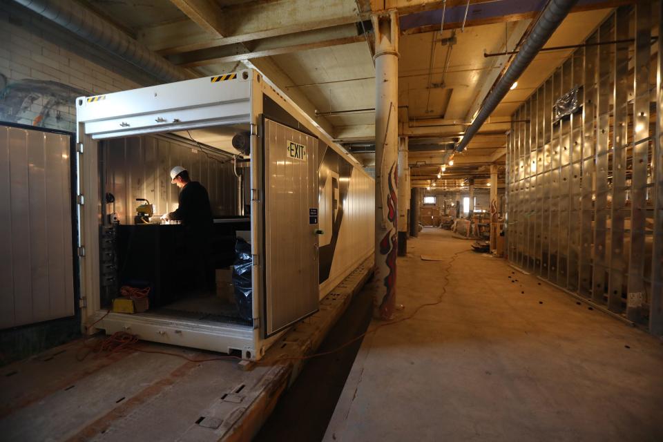 Urban Fruits and Veggies is expanding places to grow, including a shipping container that's stored at Silo City along the waterfront in Buffalo. Farm manager Rickey Fleming works to set up the Freight Farm on Nov. 9 so that once they have the power and water turned on they can start growing vegetables.