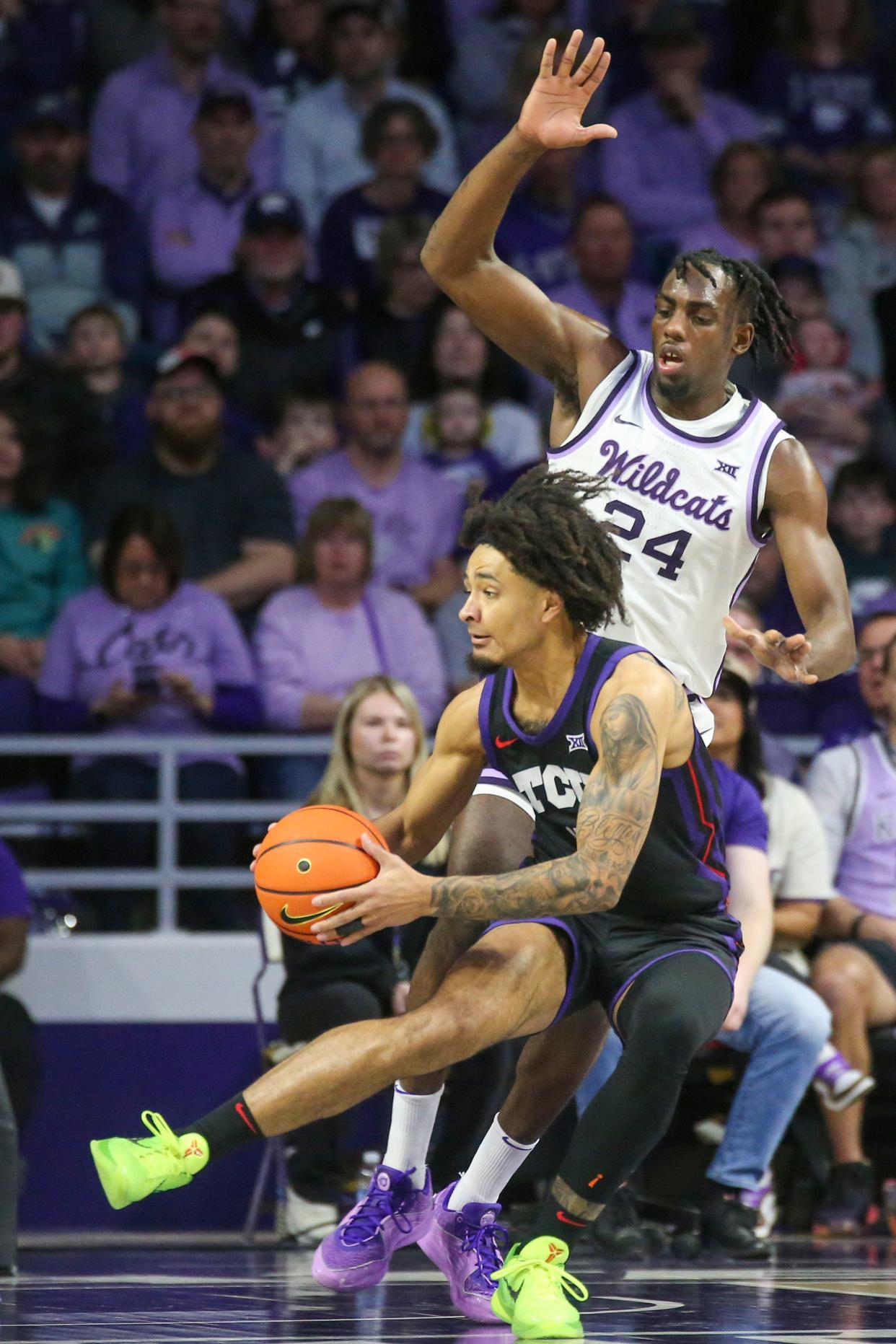 TCU guard Micah Peavy (0) is guarded by Kansas State's Arthur Kaluma (24) during Saturday's game at Bramlage Coliseum.