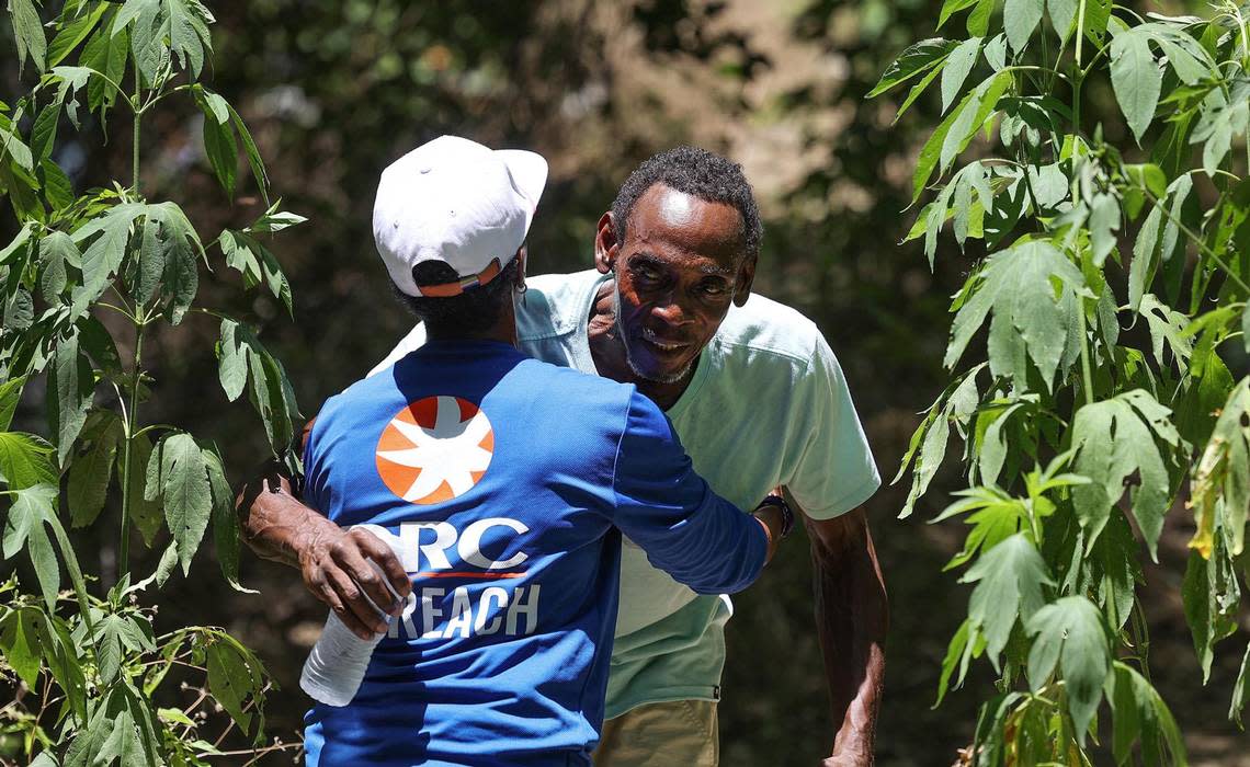 Fatimah Robertson hugs Gary Randle, 61, while working to bring water and other supplies to those living outside in the heat on Friday, June 30, 2023. Robertson says she had a special relationship with Randle, who died from suspected heat exposure in August. Amanda McCoy/amccoy@star-telegram.com