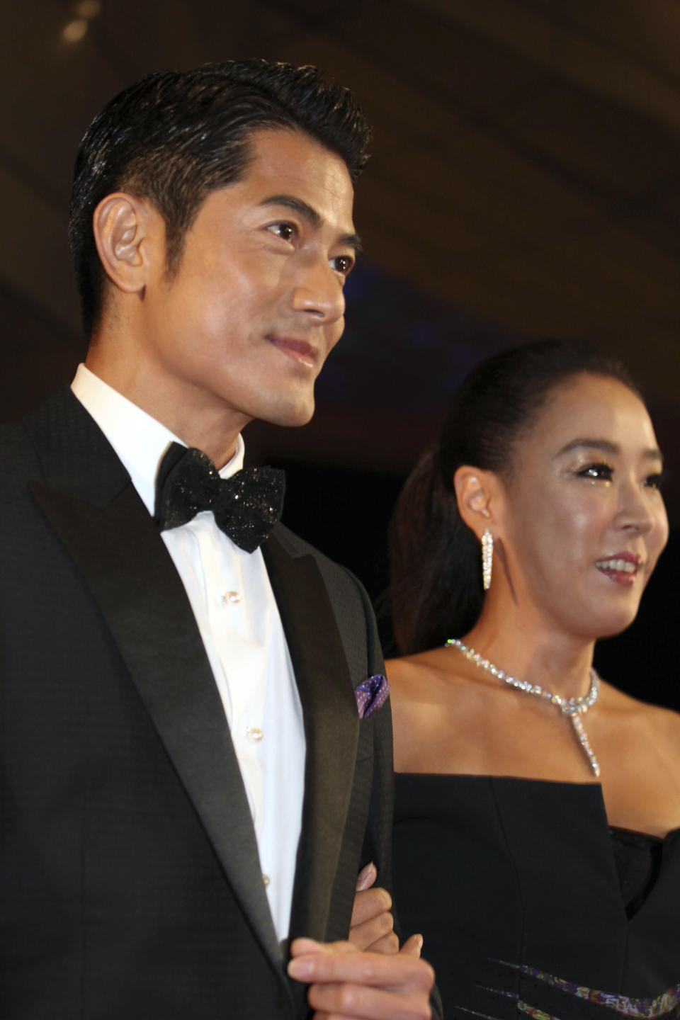 FILE - In this Thursday, Oct. 3, 2013 file photo, Chinese actor Aaron Kwok and South Korean actress Kang Soo-yeon arrive at the opening ceremony of the Busan International Film Festival at Busan Cinema Center in Busan, south of Seoul, South Korea. What would be the price for hiring Asia's biggest movie stars to host the region's largest film event? Kwok opened this year's Busan International Film Festival for mere 500,000 won or $465, according to Yang Heon Kyu, who oversees the festival's budget. The goodwill of big-name stars is one indication of how important Busan has become to the Asian film industry in less than two decades. (AP Photo/Woohae Cho, File)