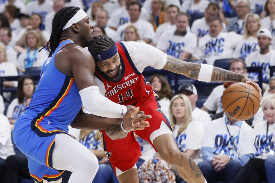 New Orleans Pelicans forward Brandon Ingram, right, drives against Oklahoma City Thunder guard Luguentz Dort during the second half in Game 2 of an NBA basketball first-round playoff series Wednesday, April 24, 2024, in Oklahoma City. (AP Photo/Nate Billings)