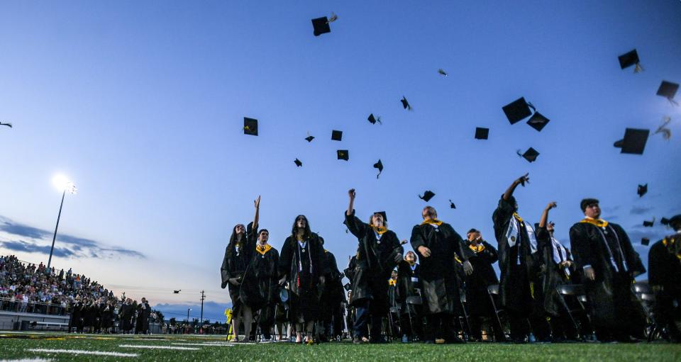 Graduates toss their caps in the air during the Crescent High School commencement at the school stadium in Iva, S.C. Monday, May 20, 2024.
