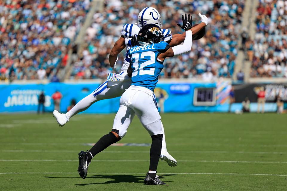 Jacksonville Jaguars cornerback Tyson Campbell (32) breaks up a pass on Indianapolis Colts running back Jonathan Taylor (28) during the first quarter of an NFL football matchup Sunday, Oct. 15, 2023 at EverBank Stadium in Jacksonville, Fla. The Jacksonville Jaguars defeated the Indianapolis Colts 37-20. [Corey Perrine/Florida Times-Union]