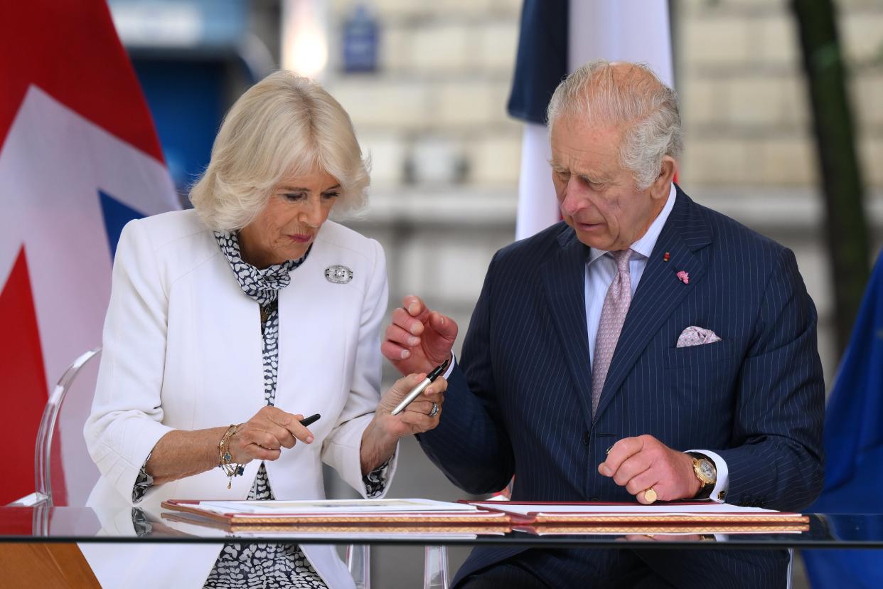 King Charles III and Queen Camilla sign a book after visiting the central Paris Flower Market in Paris (Daniel Leal/PA Wire)