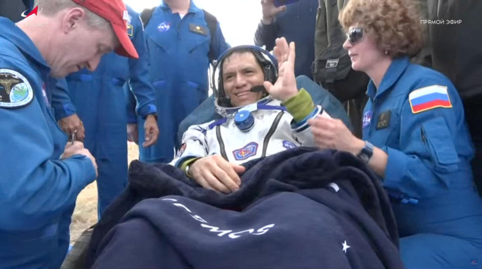 Frank Rubio, smiling and showing an enthusiastic thumbs up, was carried from the Soyuz to a nearby recliner while a flight surgeon and nurse carry out initial medical checks. / Credit: Roscosmos via NASA