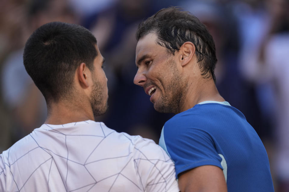 FILE - Spain's Rafael Nadal, right, congratulates Spain's Carlos Alcaraz after their match at the Mutua Madrid Open tennis tournament in Madrid, Friday, May 6, 2022. Nadal and Alcaraz are scheduled to meet in an exhibition match in Las Vegas on March 5. The match — being touted, boxing-style, as “The Slam: Nadal vs. Alcaraz” — will be held inside the MGM Grand Garden Arena. (AP Photo/Bernat Armangue, File)