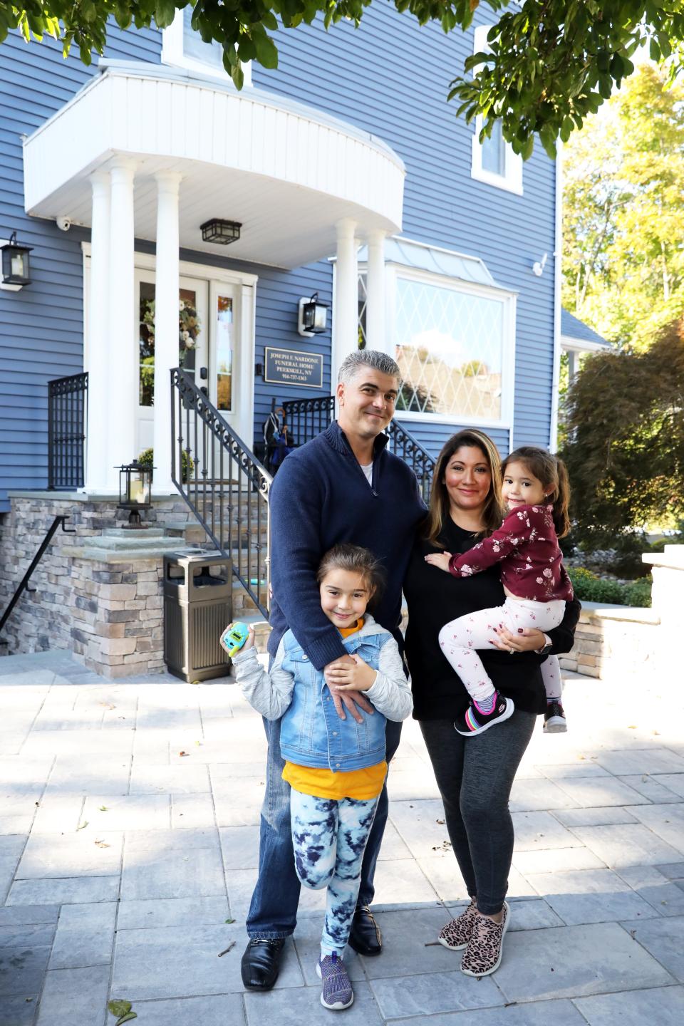 Jason and Leslie Chiaramonte with daughters Brooklyn, 6, and Phoenix, 3, outside the Joseph F. Nardone Funeral Home in Peekskill, where Mr. Chiaramonte is the funeral director, Oct. 9, 2020.