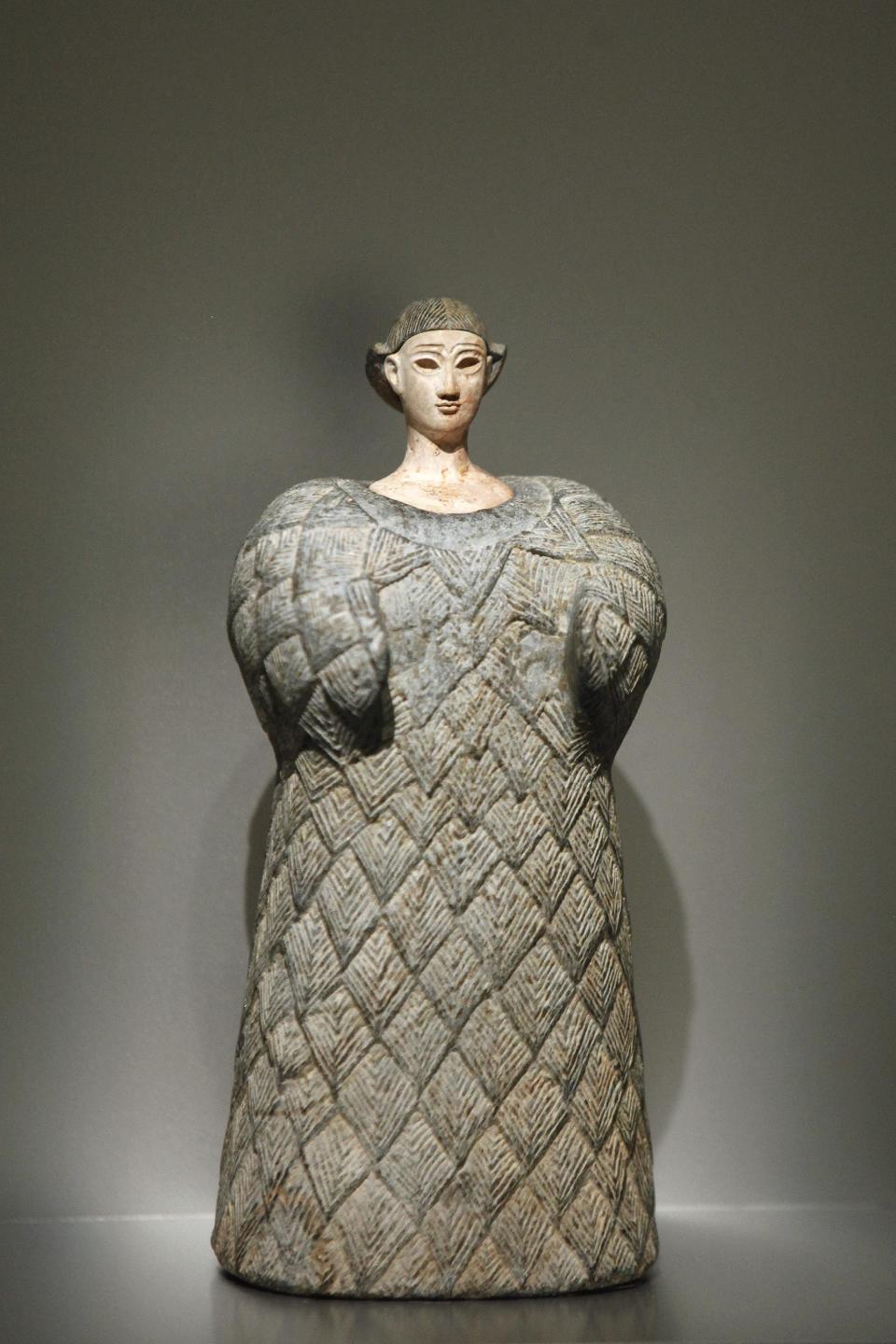 The statuette "Bactrian Princess" (late third early second millenium bc), is displayed as part of the exhibition "Louvre Abu Dhabi. Birth of a museum", at the Louvre museum, in Paris, Monday, April 28, 2014. The Louvre Abu Dhabi, the Persian Gulf’s first ever world museum, will open its doors in December 2015 in the arid Arab federation. Several thousand kilometers away on Tuesday the Louvre in Paris previewed the art that the Abu Dhabi project has acquired since 2009 for the first time to a European audience. (AP Photo/Thibault Camus)